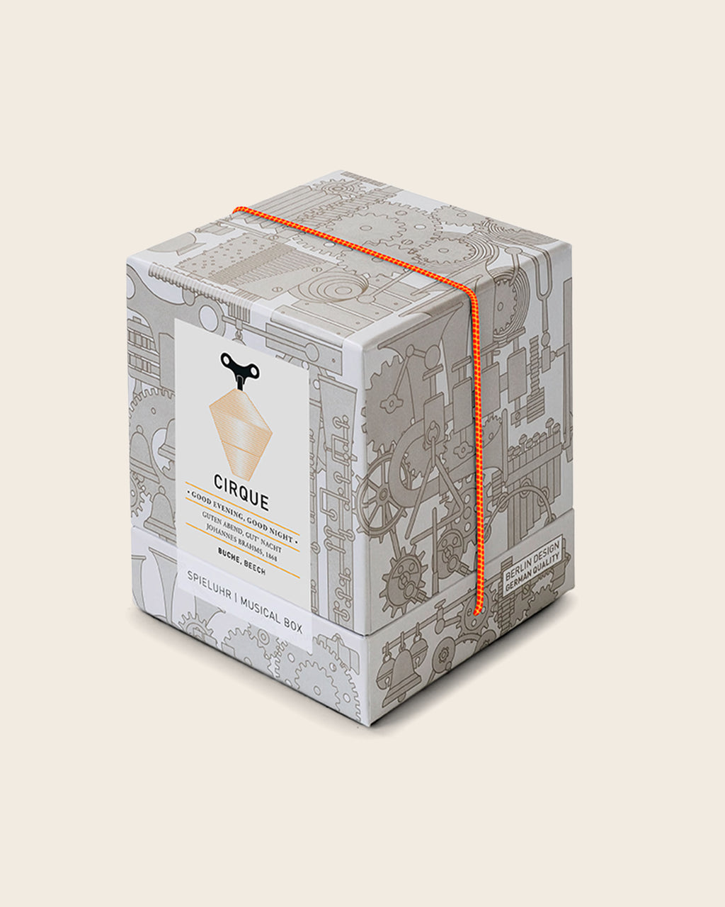 Spieluhr CIRQUE von Siebensachen in hochwertiger Geschenkbox mit grafischem Zahnraddesign und oranger Kordel. Handgefertigt im Schwarzwald aus Buche, spielt „Guten Abend, gut’ Nacht“.