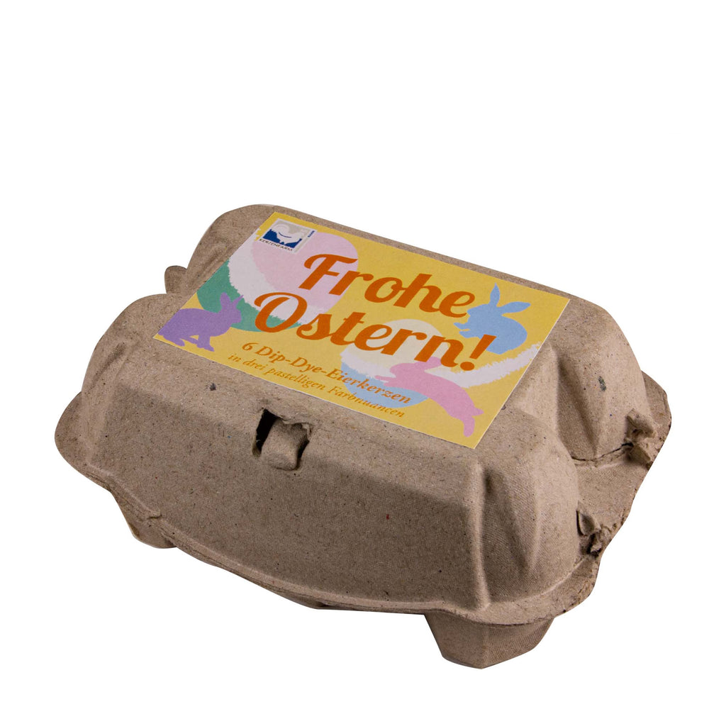 Österlicher Eierkarton mit handgetauchten Dip Dye Eierkerzen zu Ostern von Kerzenfarm Hahn mit der Aufschrift Frohe Ostern