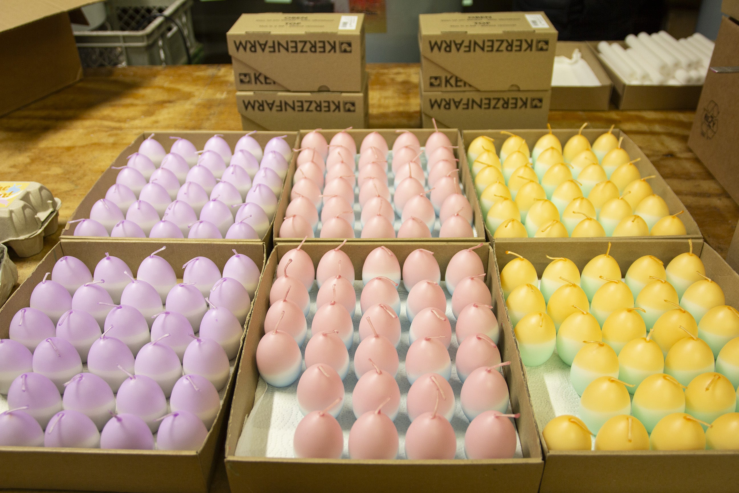 Bunte Dip Dye Osterkerzen in Eierform in großen Mengen. Gelb, rosa, lila.