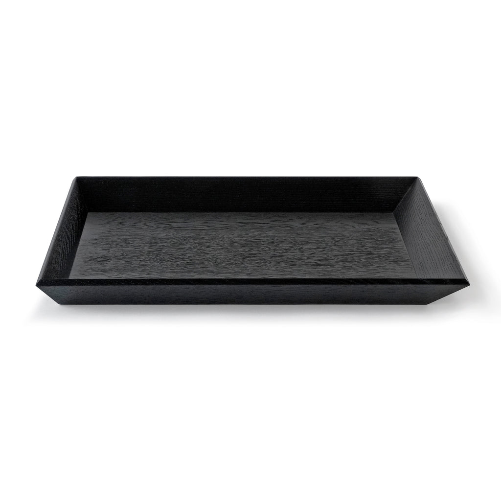 Wooden tray OBLIQUE in black oak, designed by Jörg Adam, available from Nieven Mikkaneo.