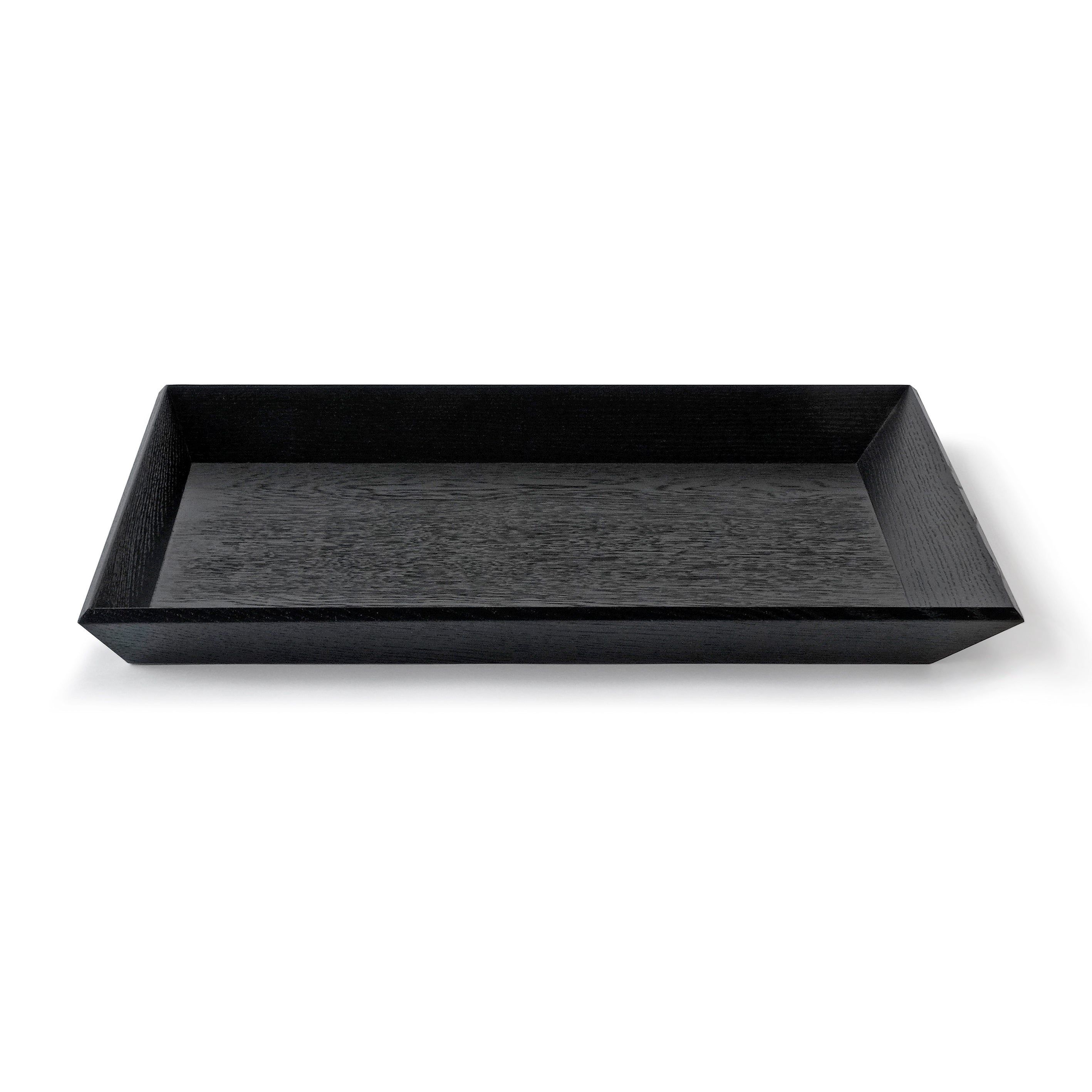 Wooden tray OBLIQUE in black oak, designed by Jörg Adam, available from Nieven Mikkaneo.