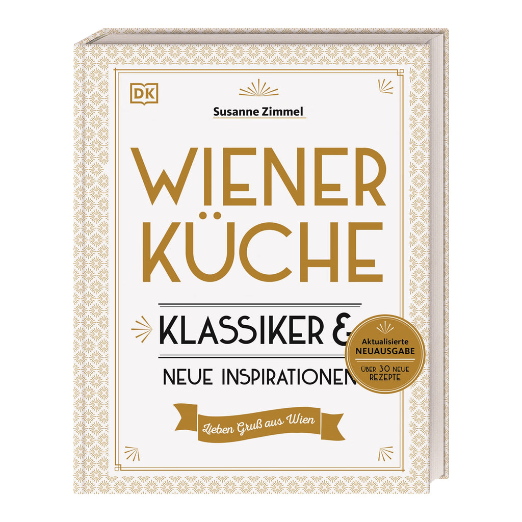 Buchcover „Wiener Küche – Klassiker & neue Inspirationen“ von Susanne Zimmel. Weißes Cover mit goldener Ornamentik und Aufschrift „Aktualisierte Neuausgabe – über 30 neue Rezepte“.