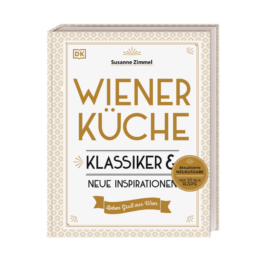 Buchcover „Wiener Küche – Klassiker & neue Inspirationen“ von Susanne Zimmel. Weißes Cover mit goldener Ornamentik und Aufschrift „Aktualisierte Neuausgabe – über 30 neue Rezepte“.