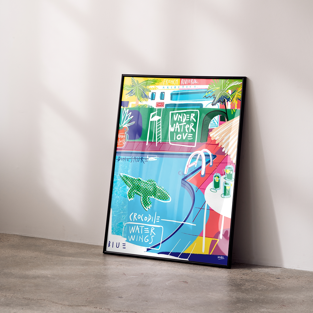 Fine Art Print French Riviera by Jean Philippe Henric leaning in a black frame against the wall. Colorful illustration with pool palm trees crocodile and the words Underwater Love. Modern Mediterranean art with summery lightness.