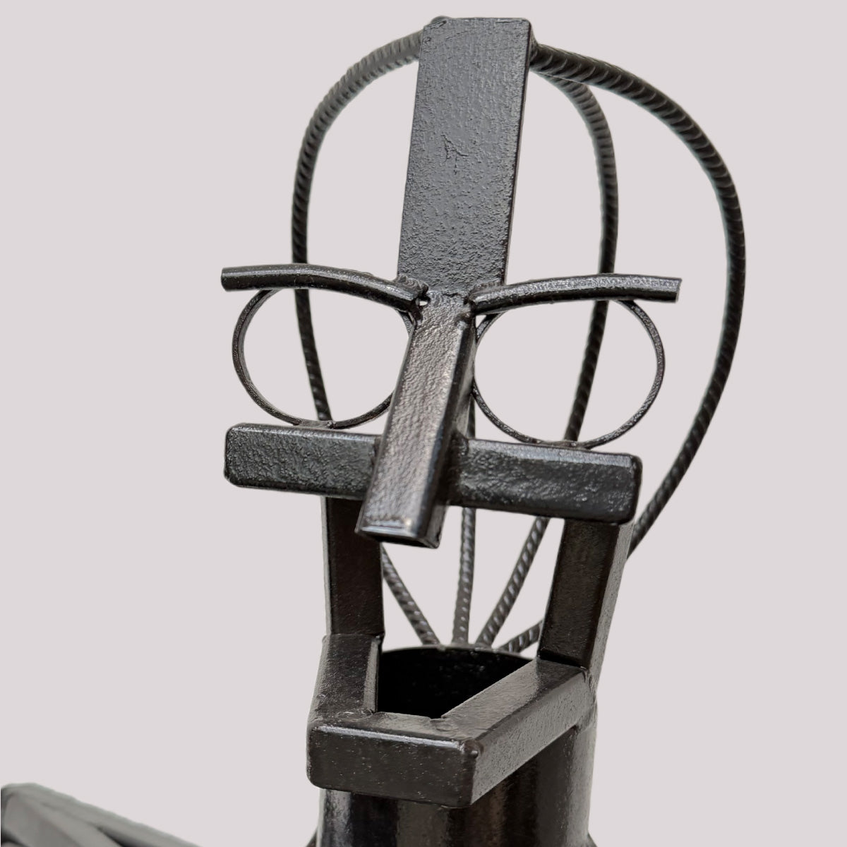 Detailansicht des Kopfbereichs der Stahlskulptur ‚Oszillator‘ von Till Kräusel mit abstrahierter Gesichtsform aus geschweißten Metallstäben und schwarzer Stahloberfläche